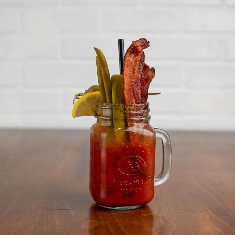 Bloody Mary with pickle and bacon garnish