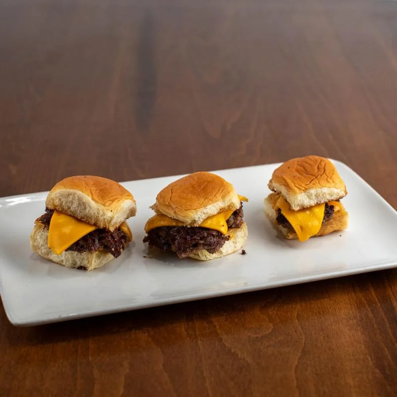 Three Rewsters smash sliders on a white plate