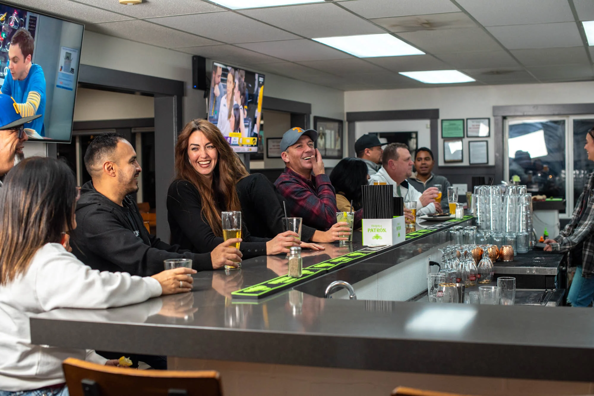 Friends enjoying drinks and conversation at the Rewsters bar